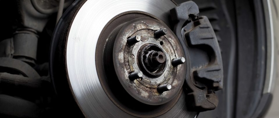 Brake disc, caliper and wheel hub on a car with the wheel removed