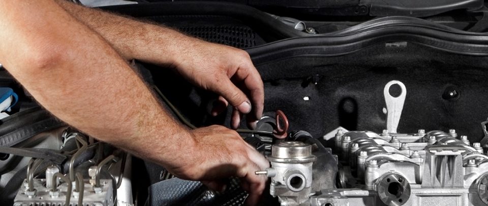 Mechanic working by hand on an engine